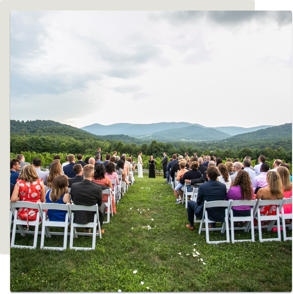 large outdoor wedding with mountains in the background